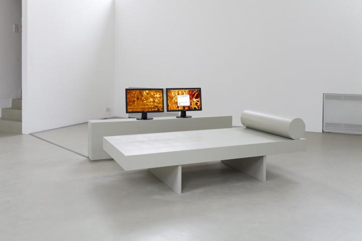 The picture shows two screens showing a golden structure similar to lava, in front of which stands a white seat and lying surface