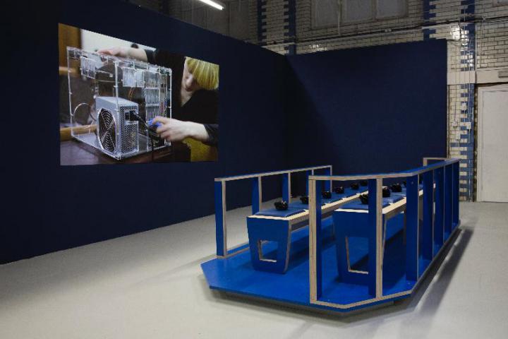 Blue seat installation with headphones in front of a screen