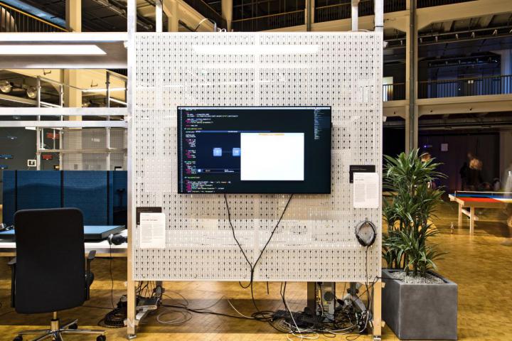 Installation view of a screen on a grey wall display