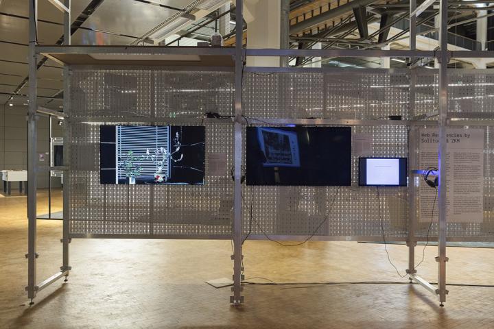 The picture shows three screens attached to a grid structure