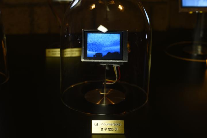 The photo shows a glass bell with a small screen.
