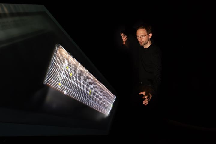 The artist Gero Koenig next to his installation »Chordeograph Augmented Reality«, instrument with graphic scores as interactive video installation