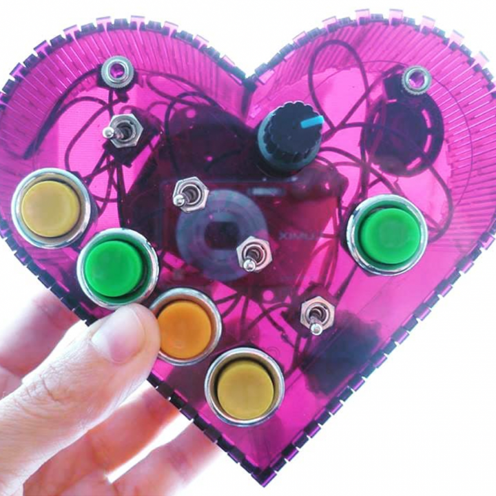 Photo of pink heart with wires and buttons