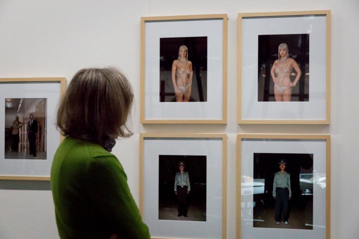 A woman looks at several photographs