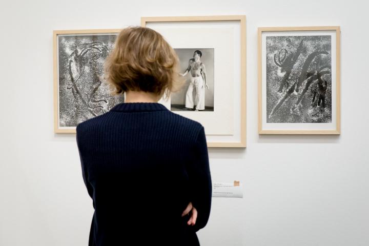 A woman is looking at different photographs