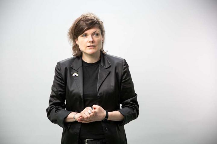 Brown-haired person in a black blazer