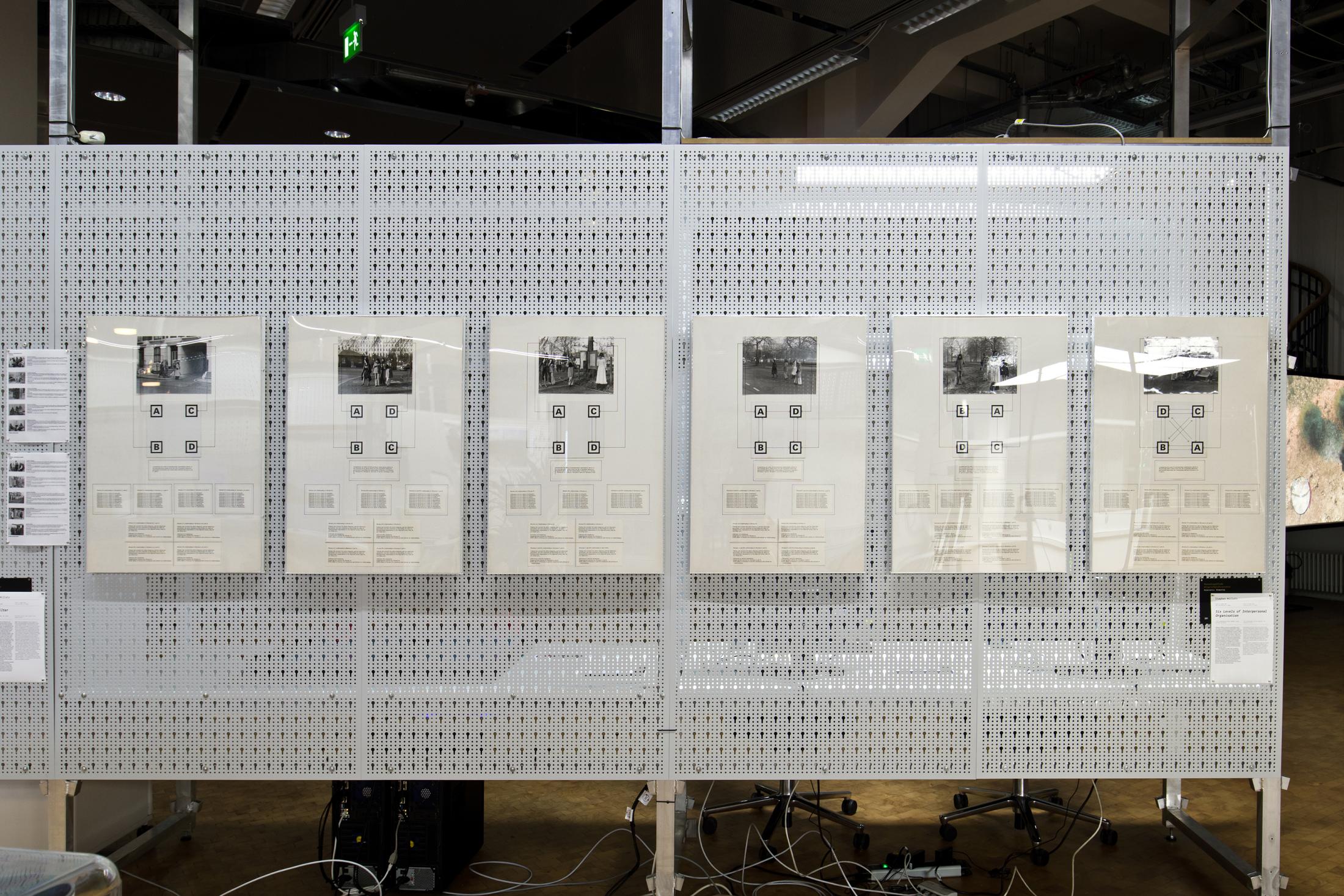 The figure shows 6 photographs with drawings hung on a white grid structure