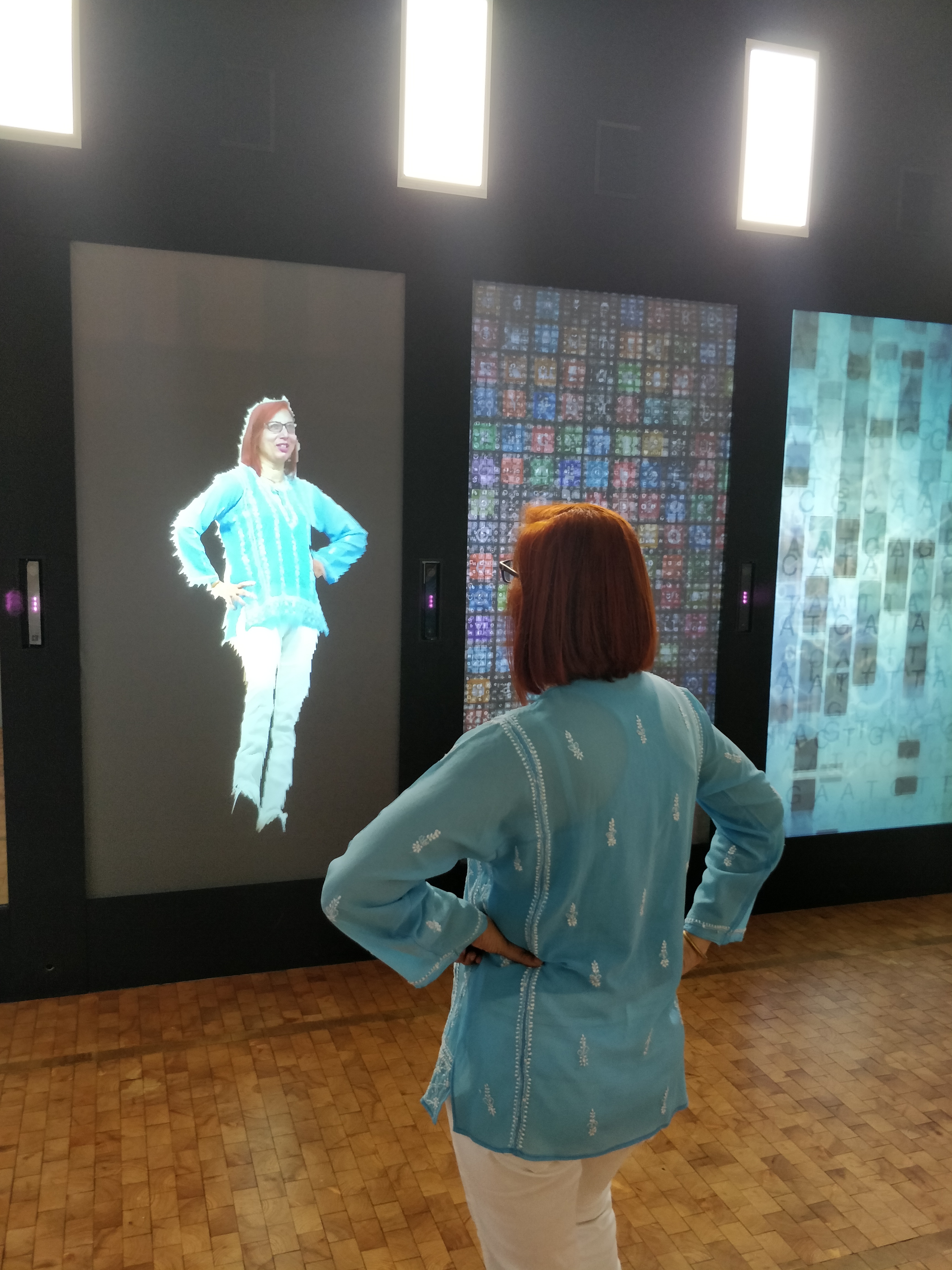 A woman faces her digital reflection