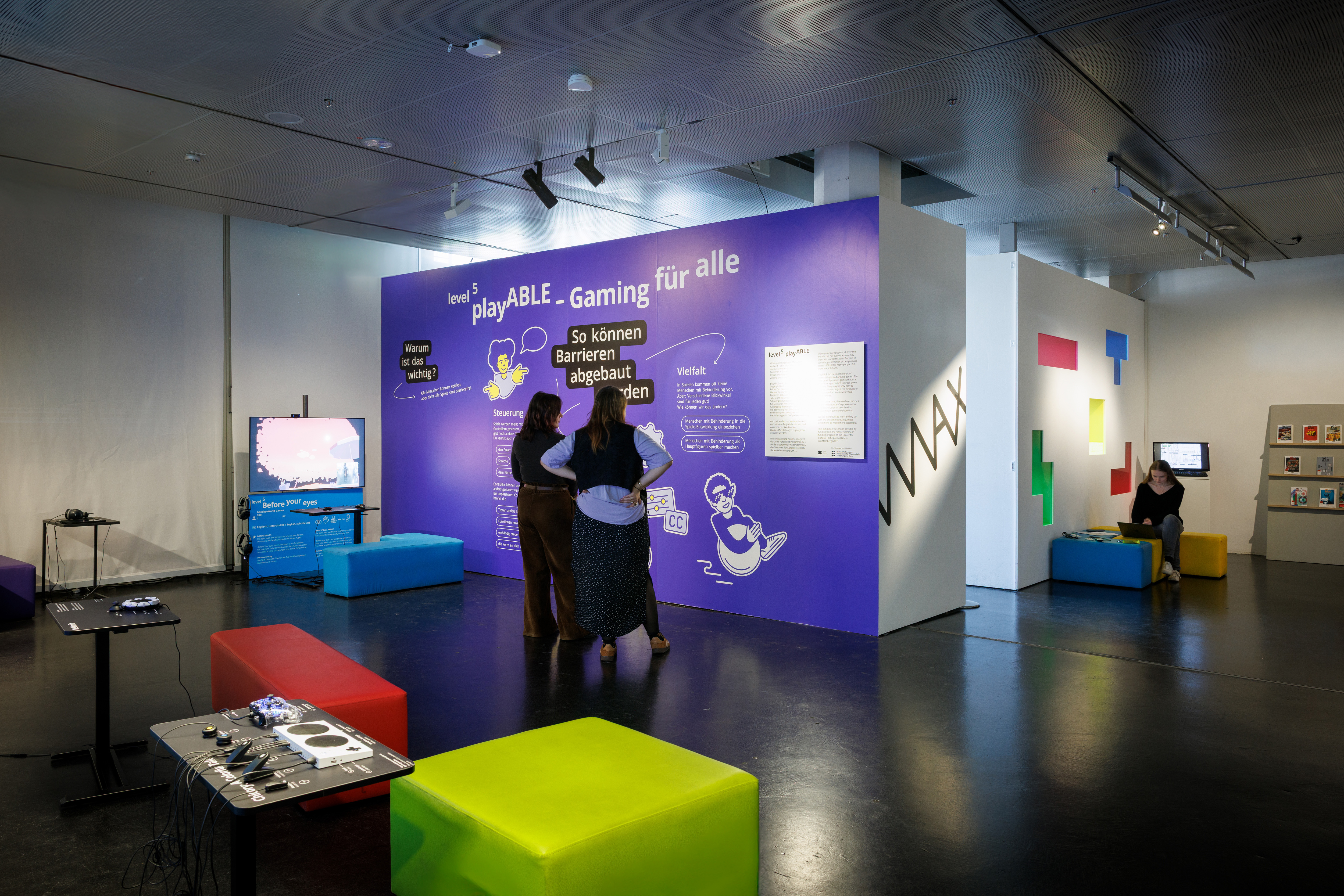 Level 5 of the exhibition zkm_gameplay, people in an exhibition with video games.
