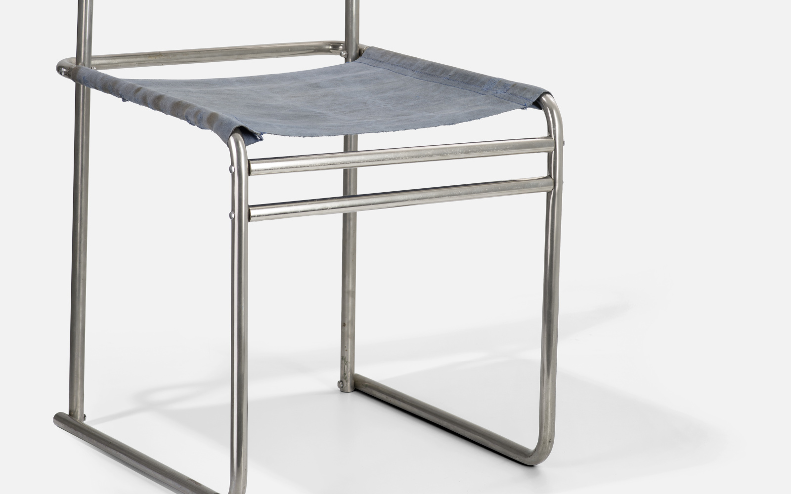 Ein Stuhl, dessen Gerüst aus Metallstangen besteht. Die Sitz- und Rückenfläche ist aus Stoff