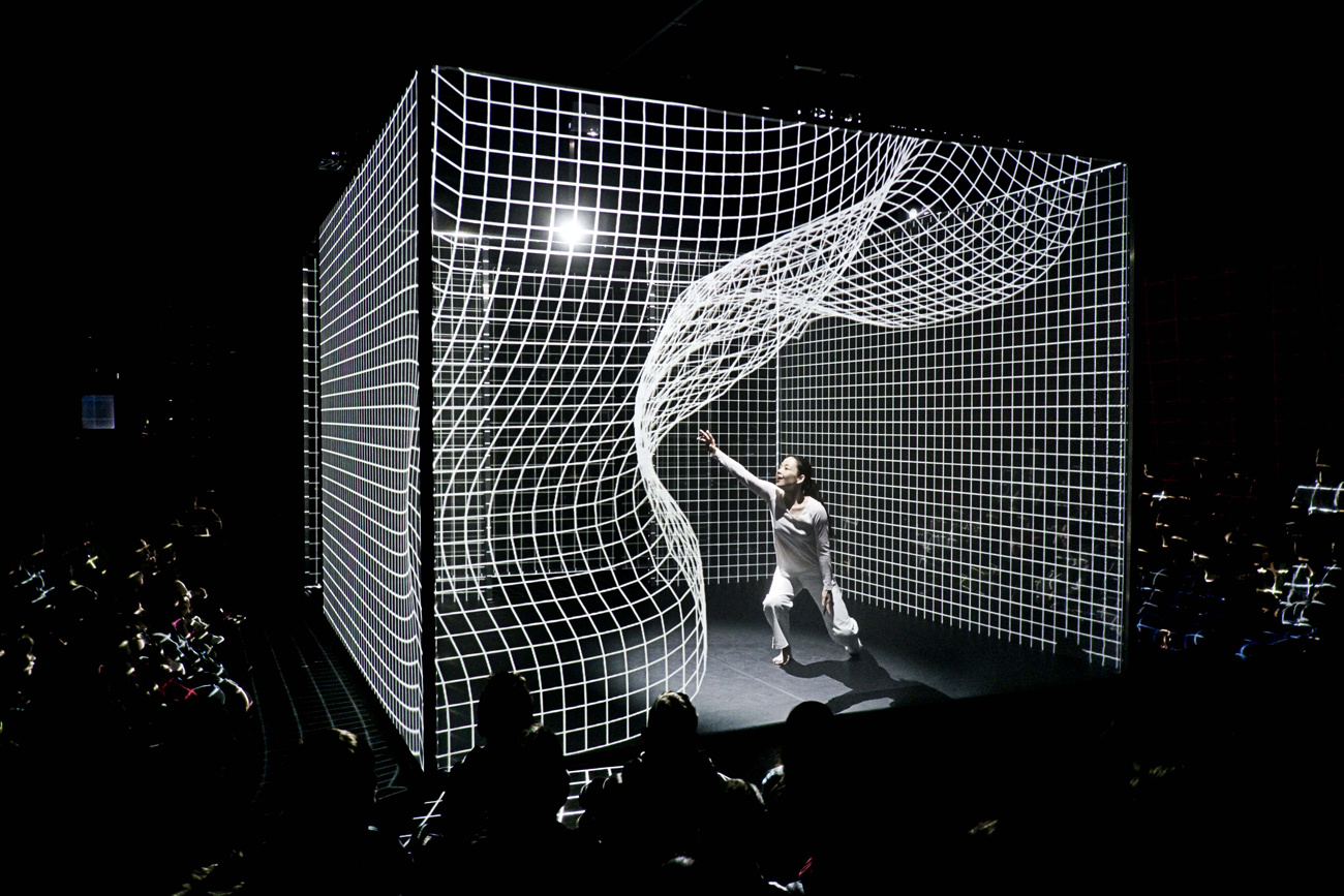 A person is dancing in the middle of an animated matrix