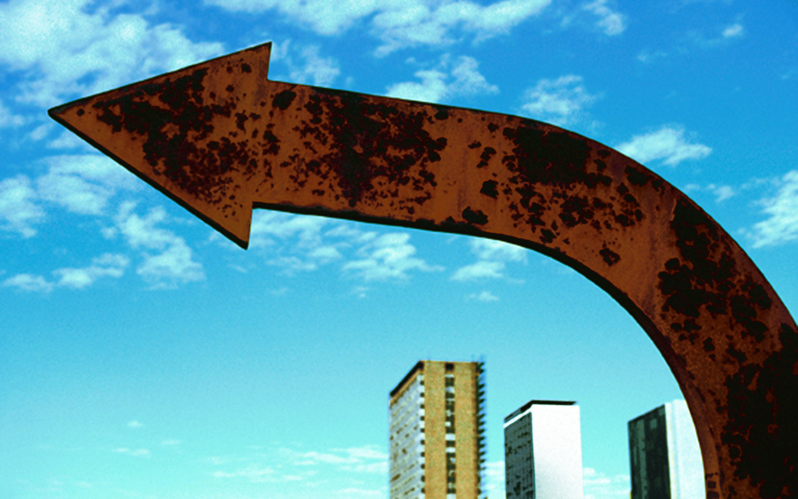 Broad arrow made of copper in front of blue sky