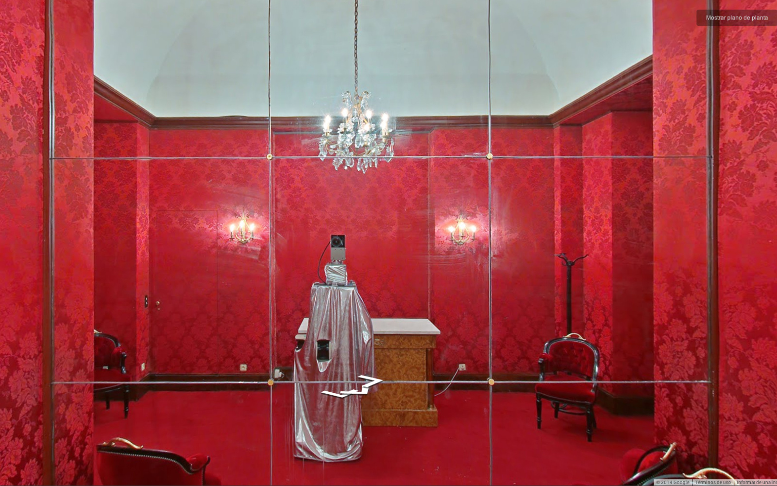 Red room with big mirror and a camera taking a "selfie" in it 