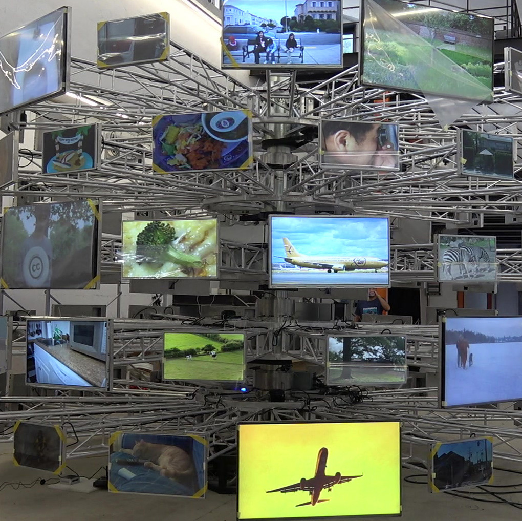 Metal framework with 80 screens, showing different pictures.