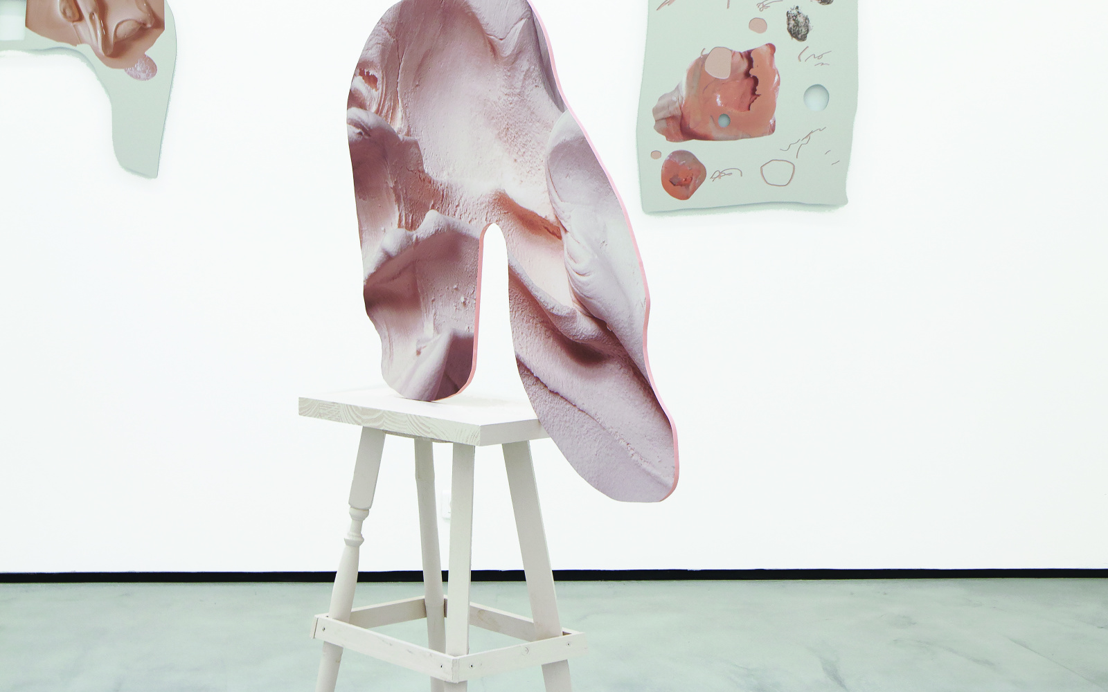 a pink organic sculture on a chair