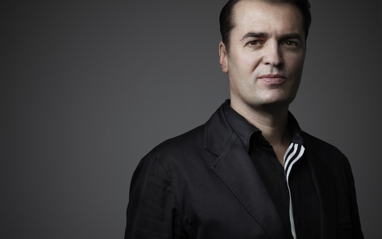 Portrait of Patrik Schumacher in a black shirt