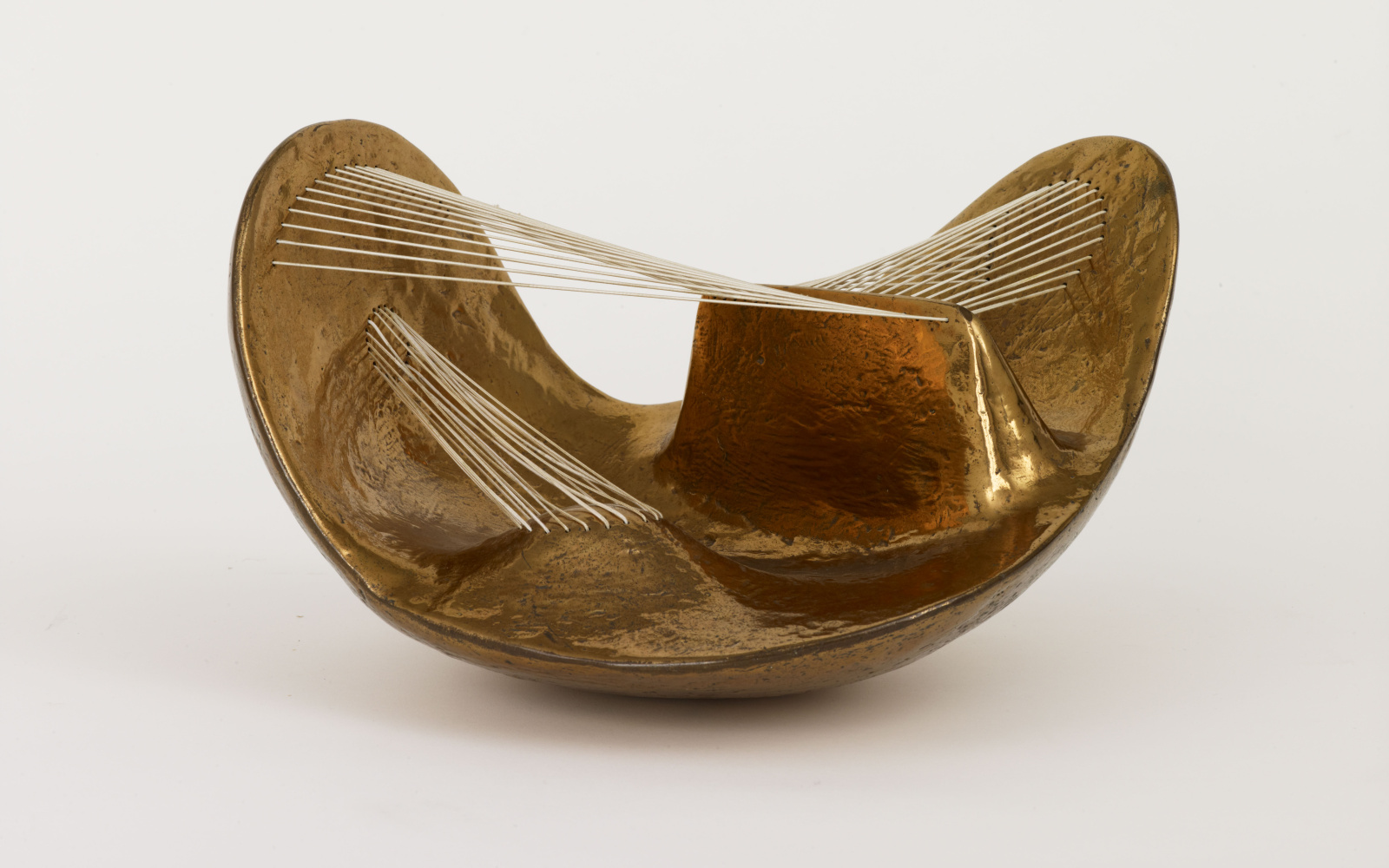 Golden bowl through which threads are stretched