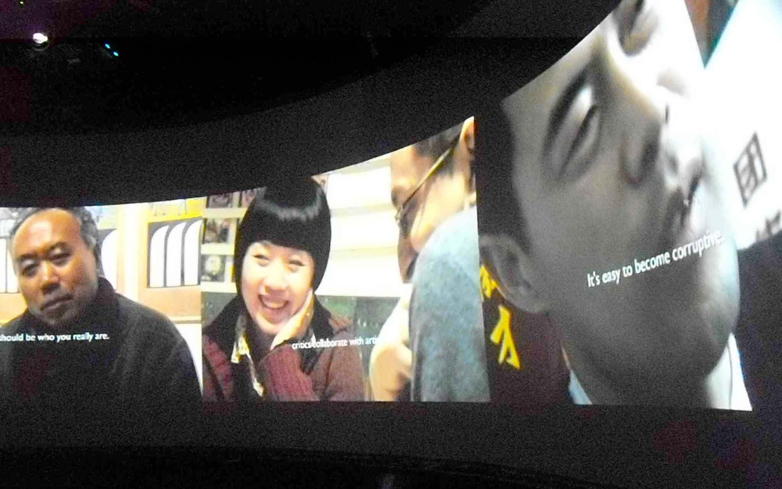 One screen with three Asian persons