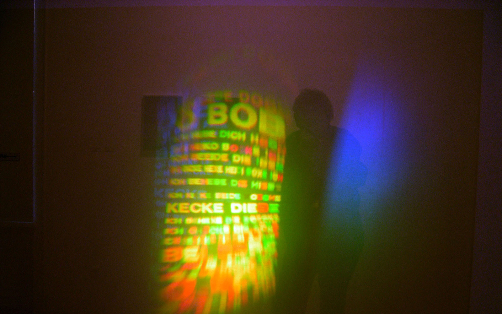 The picture shows a green-yellow light installation with letters. 