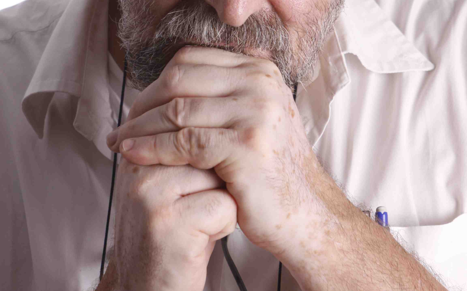 Portrait of Daniel Teruggi. He looks with his head bowed strictly straight into the camera.