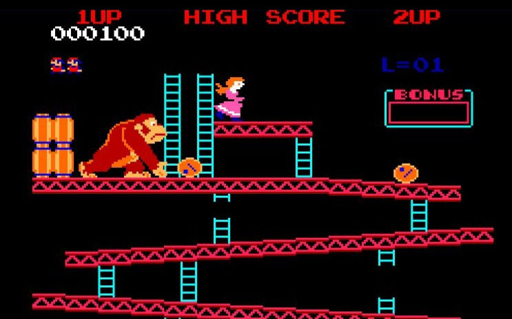 Donkey Kong lässt Fässer mehrere Stockwerke hinunterrollen. Jumpman springt über die Fässer.
