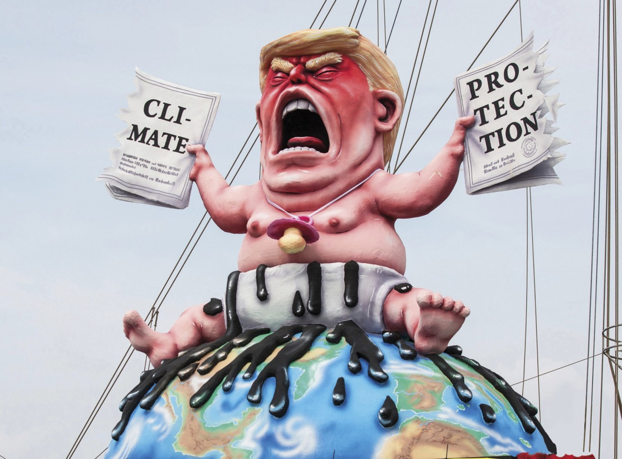 A caricature by Donald Trump shows him sitting on the globe as a baby, in one hand a paper on »Climate«, in the other a paper on »Protection«.  