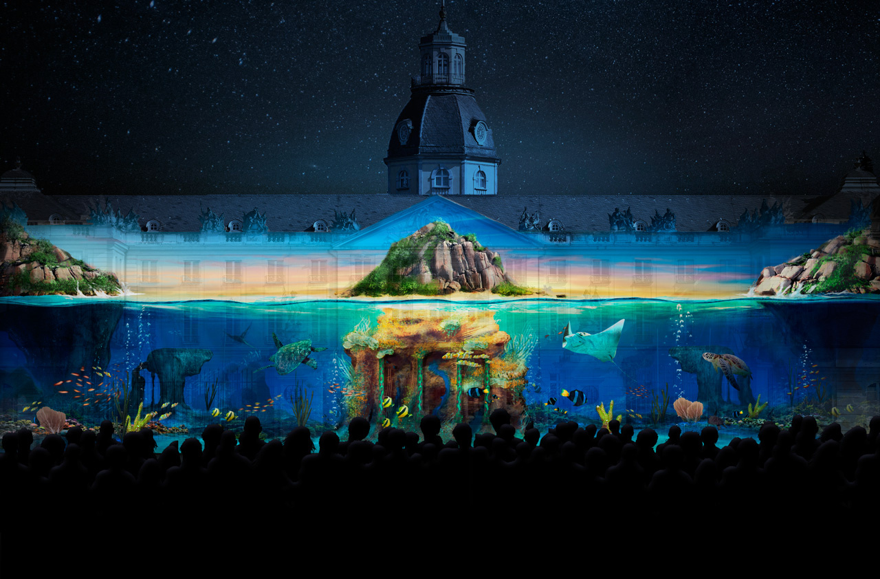 The photo shows a projection mapping of the Maxin10sity group at the Karlsruhe castle. You can see a mystical underwater world.