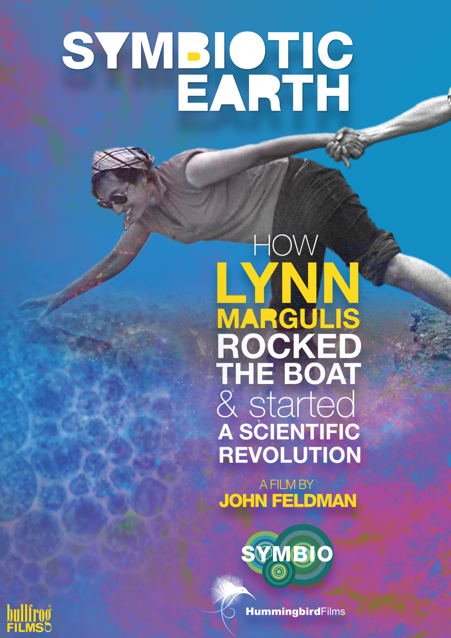 The poster of the film Symbiotic Earth shows Lynn Margulis with one hand and one leg in the water, with the other leg on the ground and with the other hand holding a strange hand
