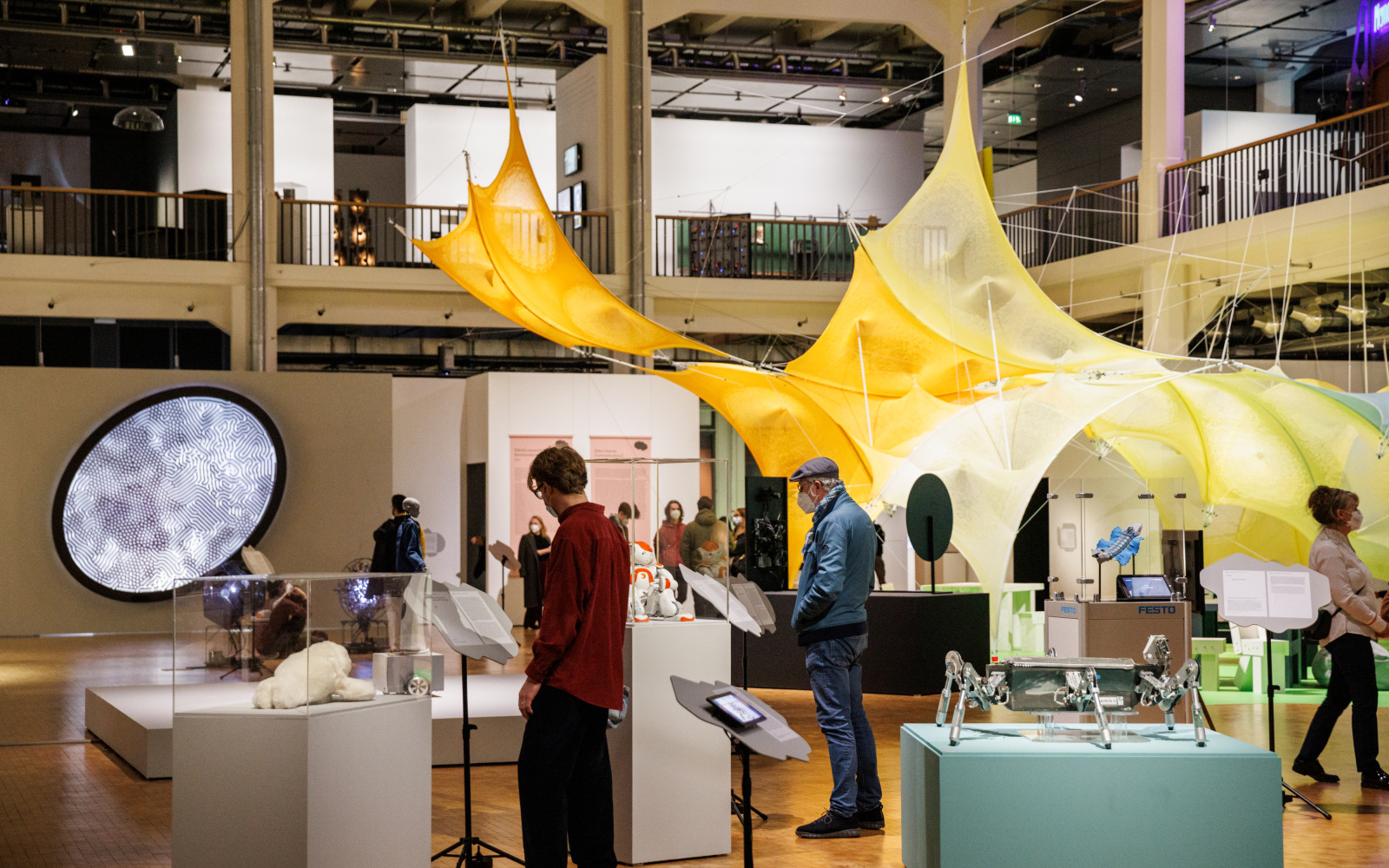 People look at exhibits of an exhibition