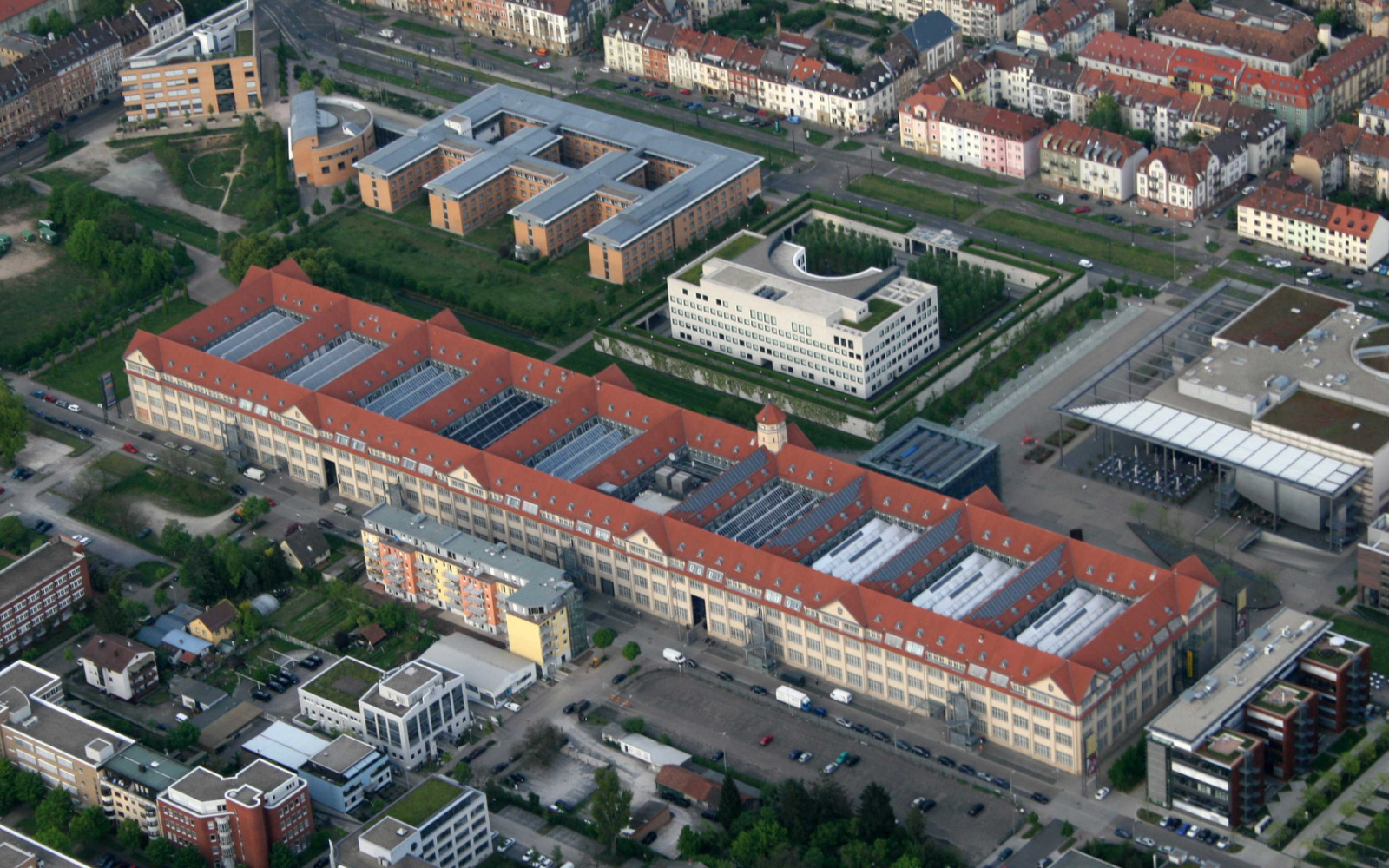 The photo shows an aerial view of Hallenbau A in Lorenzstraße. The home of the Städtische Galerie, the ZKM | Karlsruhe and the Staatliche Hochschule für Gestaltung Karlsruhe.