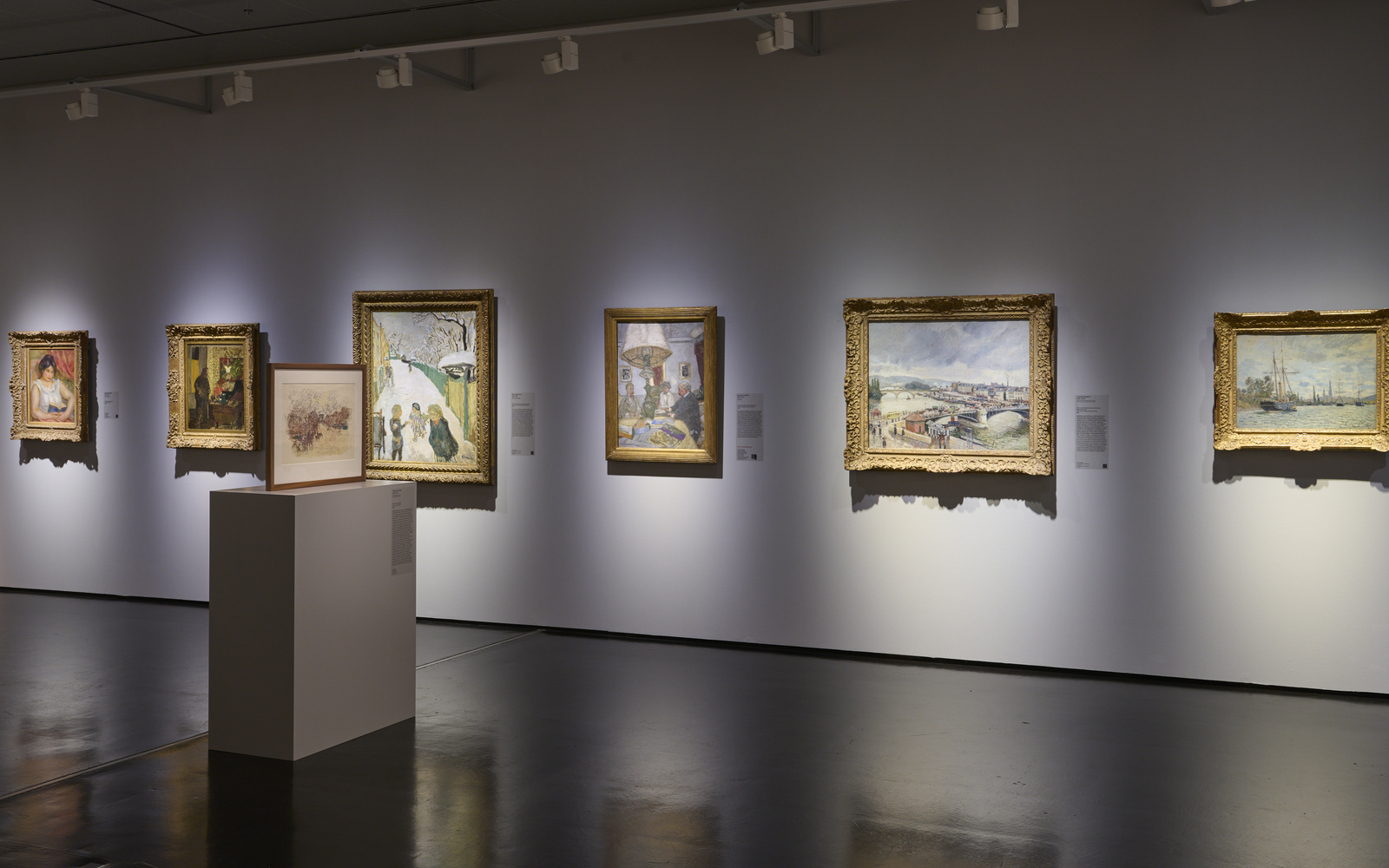 Illuminated pictures hanging in a dark room