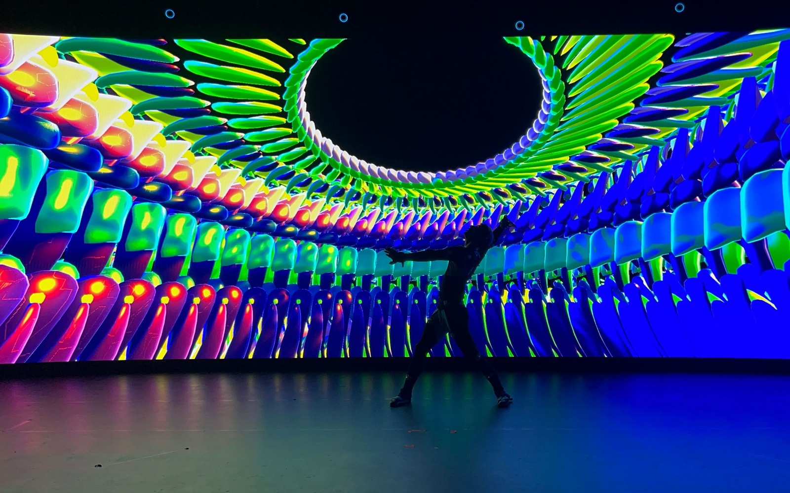 Dancer in a room filled with artistic lights