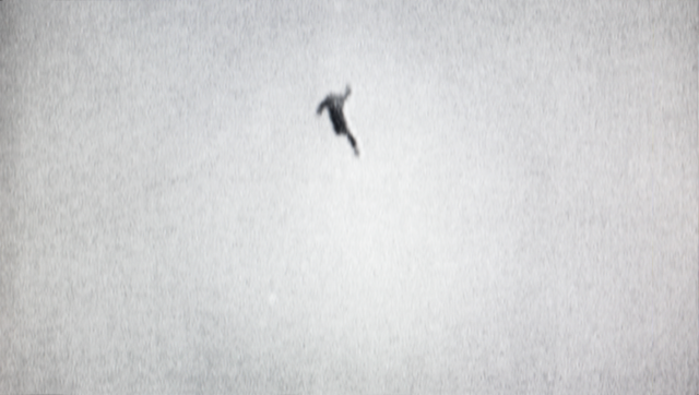 Black and white photo of a person in the air