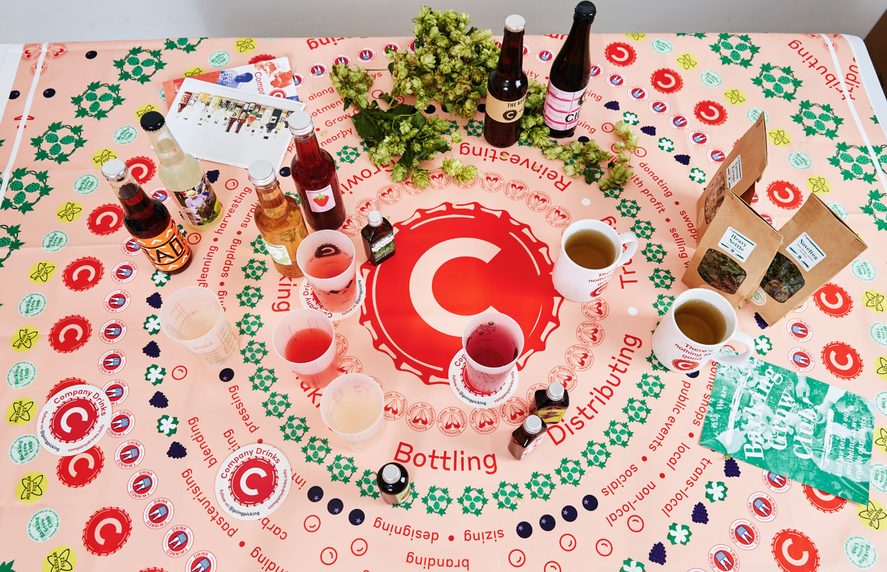 The picture shows a table with various drinks, cups, and mugs.