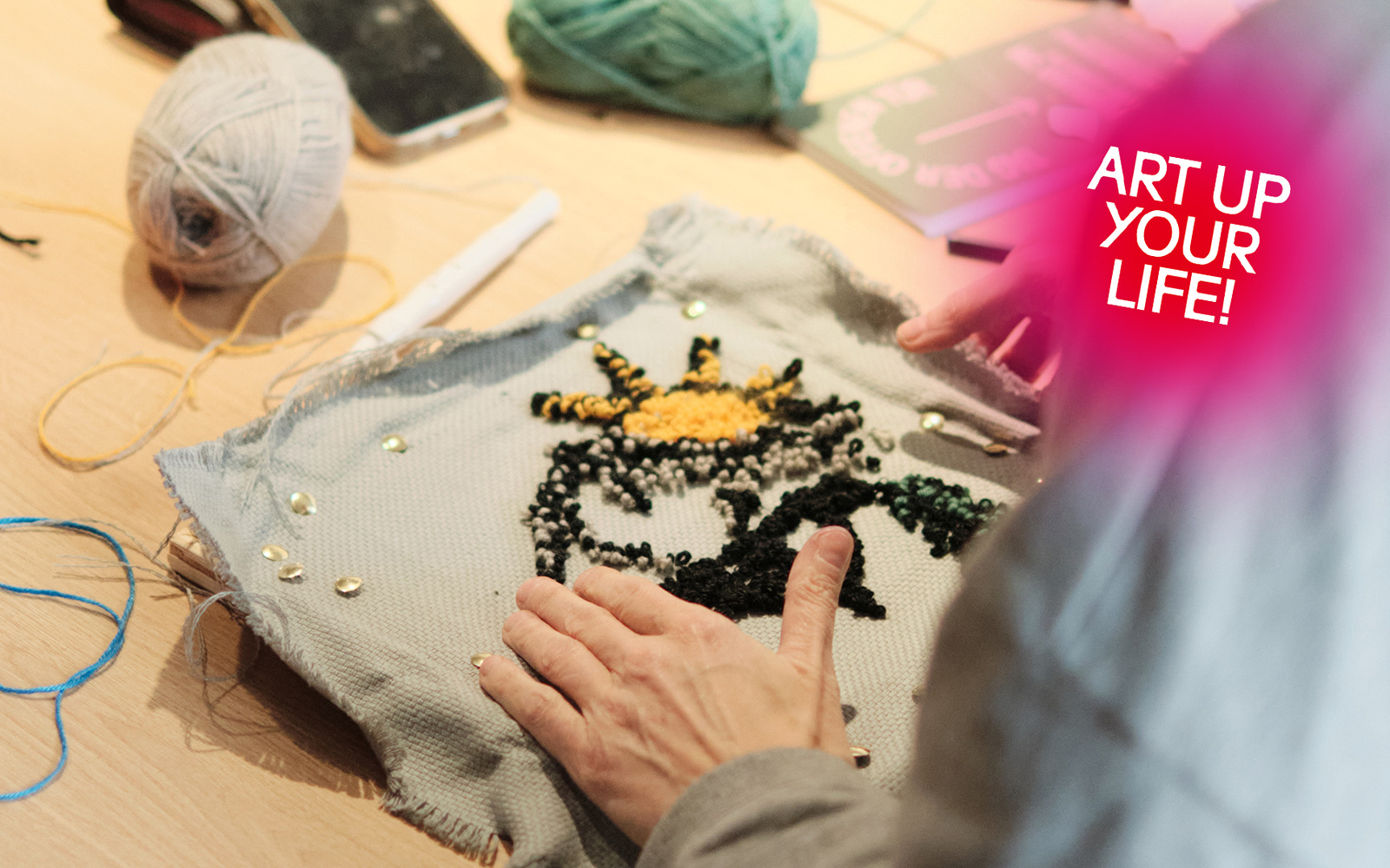 Nahaufnahme von zwei Händen bei einem Tufting-Workshop.