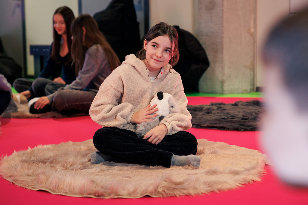 A girl with a Booboo robot guinea pig.