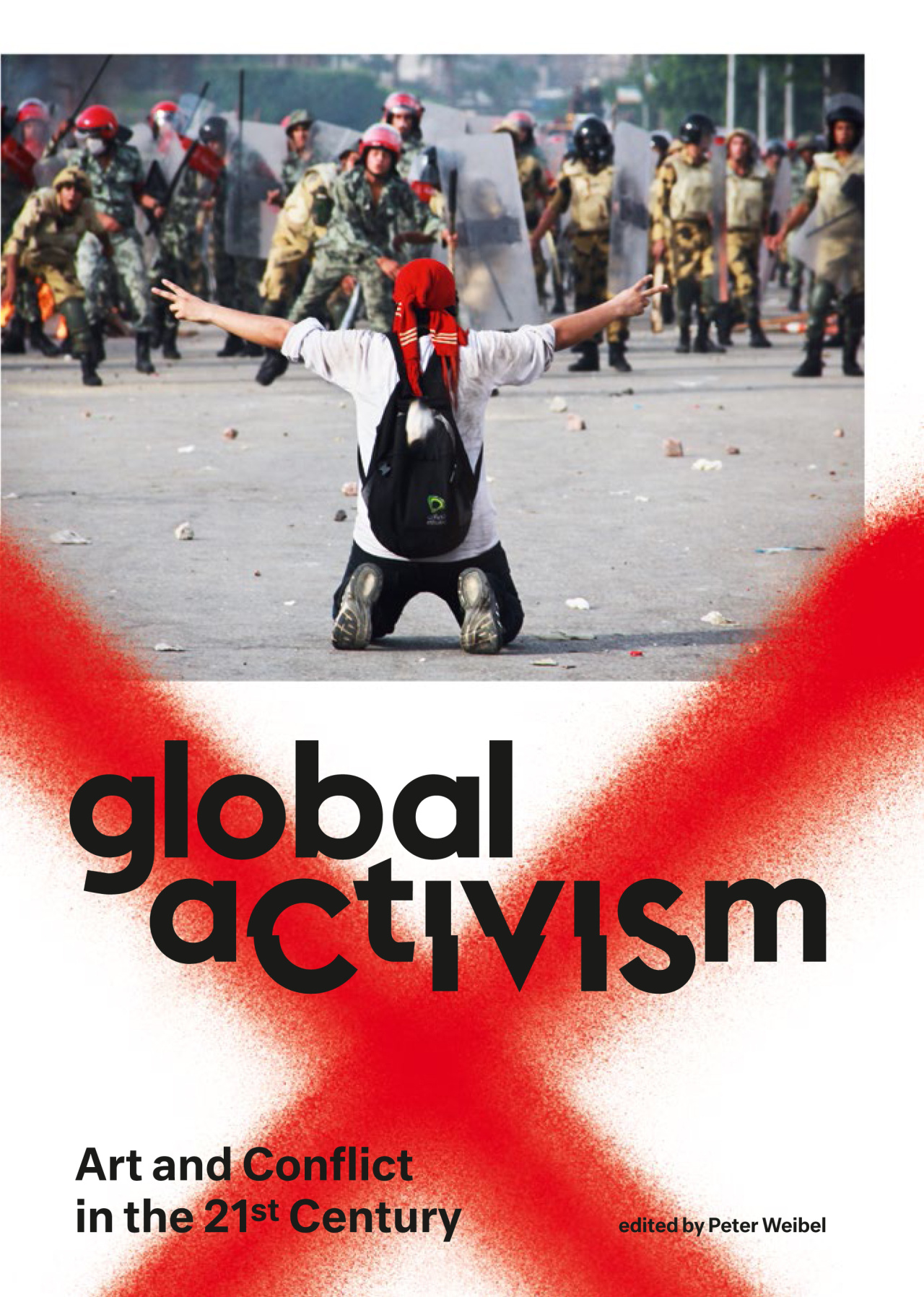  The book cover of "Global Activism" shows a photo: A man is kneeling in the street with both hands up forming the victory sign. He looks at a force of uniformed men.