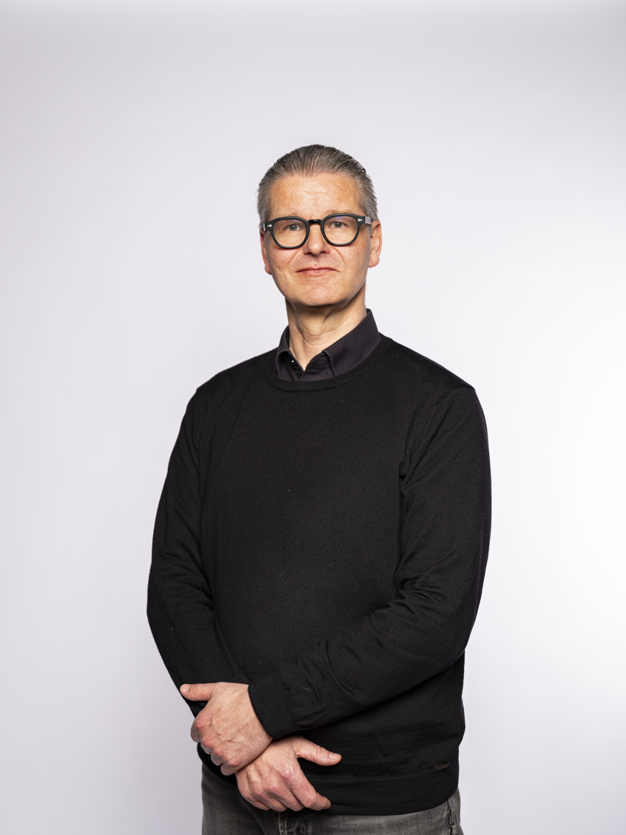 standing man with glasses and gray hair