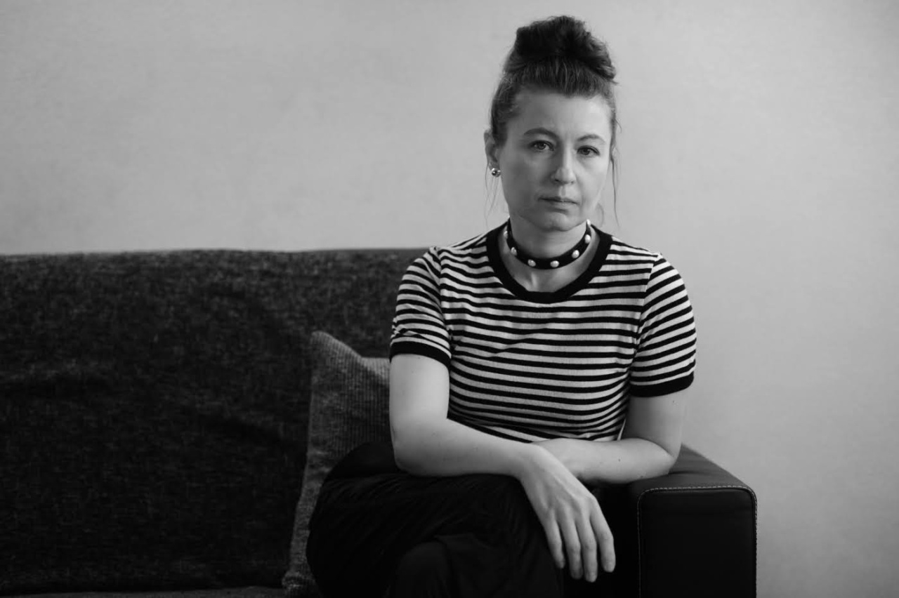 A woman with a bun and striped T-shirt