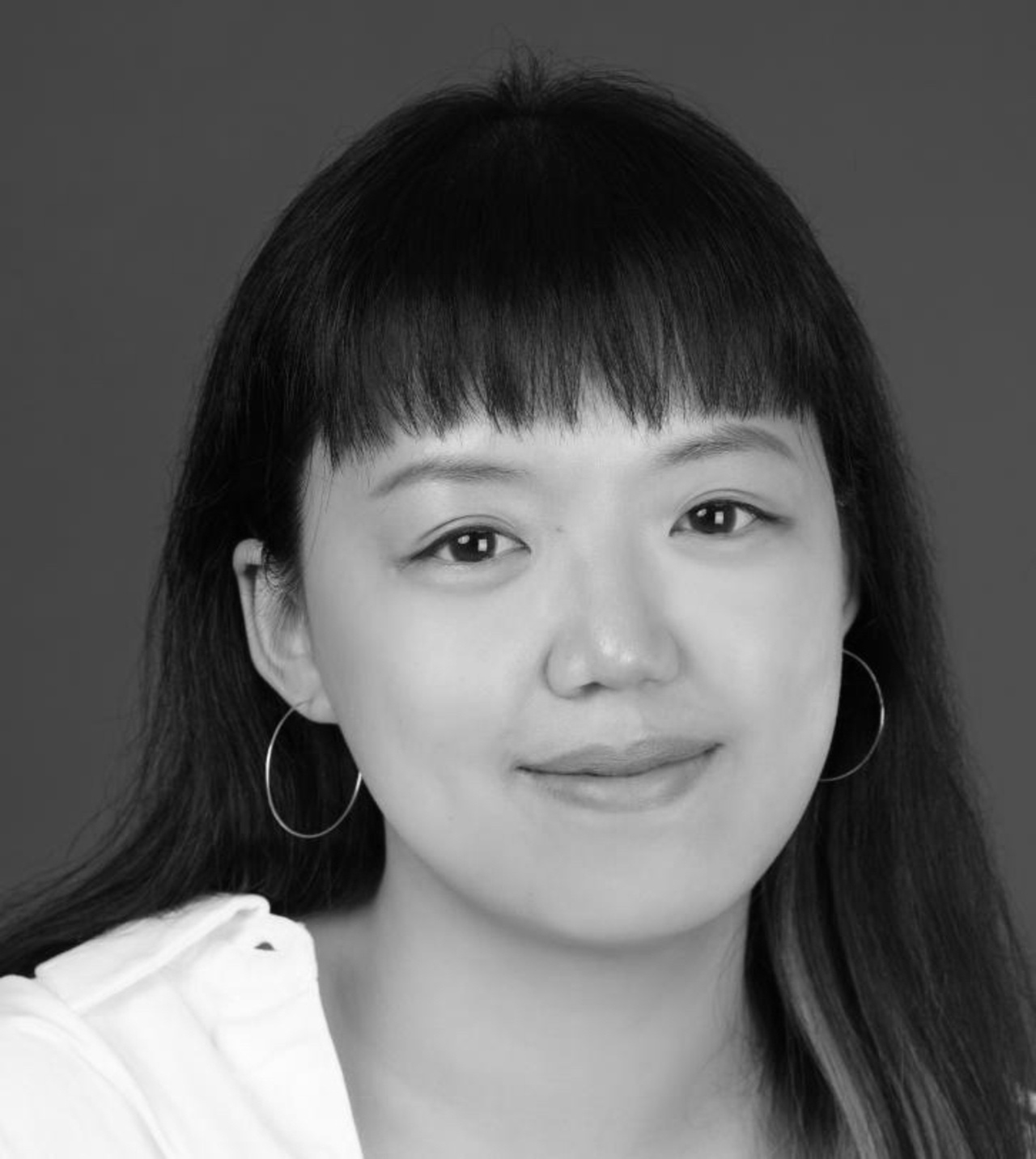 A portrait photo of a person in black and white. 