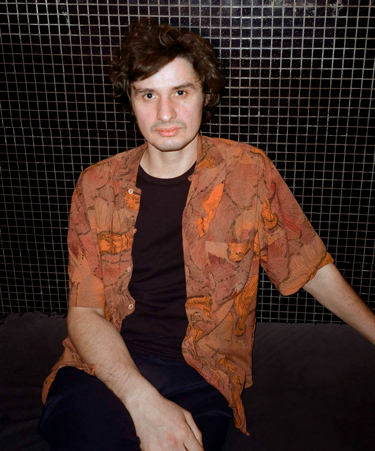 Portrait of a person in front of a black background.