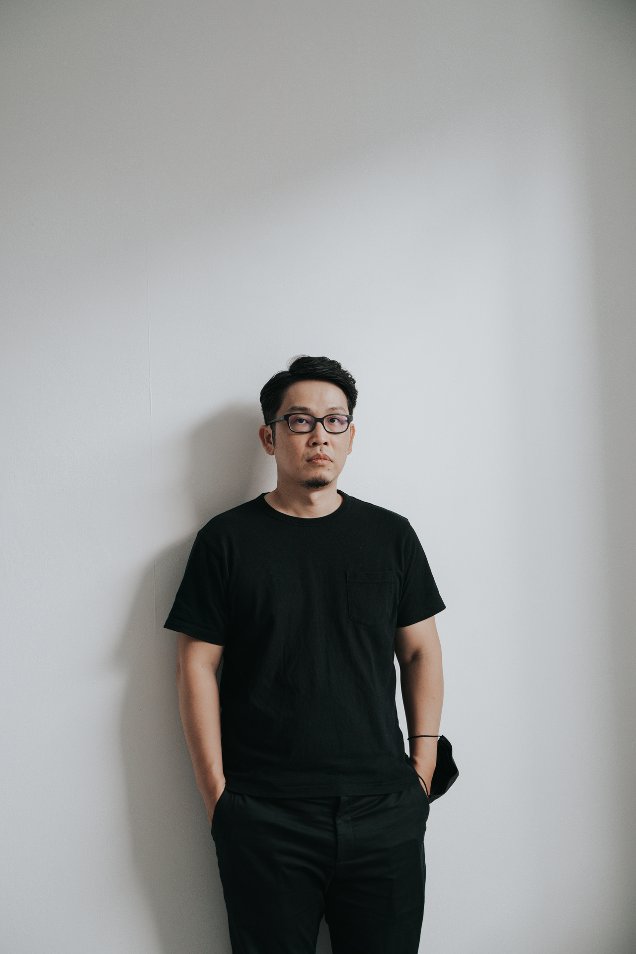 A portrait photo of a person dressed in black. 
