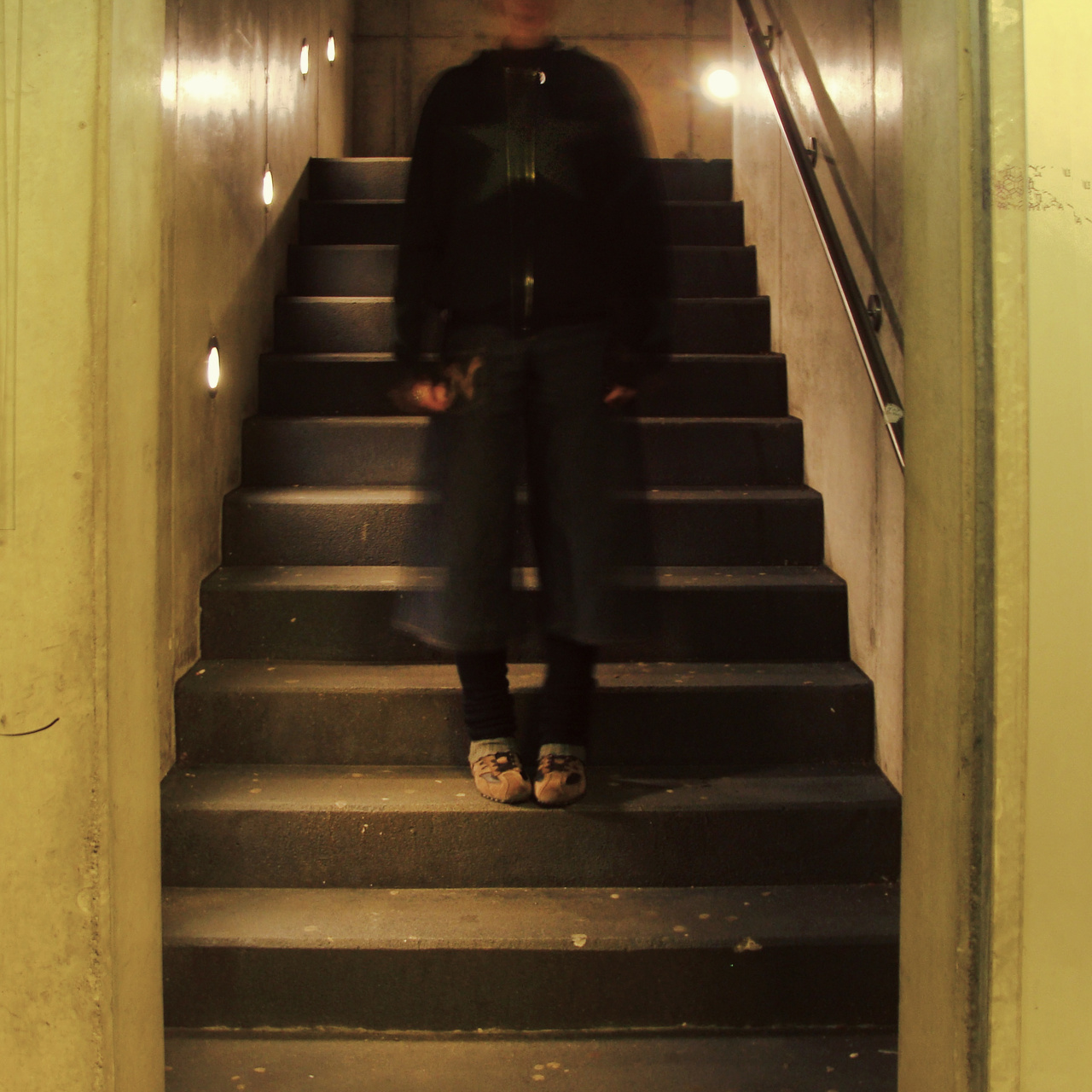 A person standing on a staircase can be seen. 
