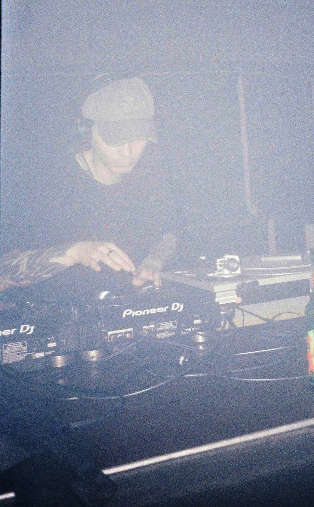 A person can be seen at a DJ desk.  