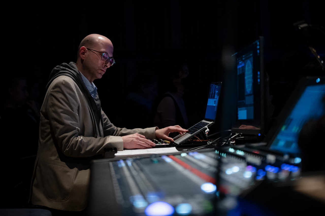 Bald man (Peter Gahn) standing in front of a mixing desk.