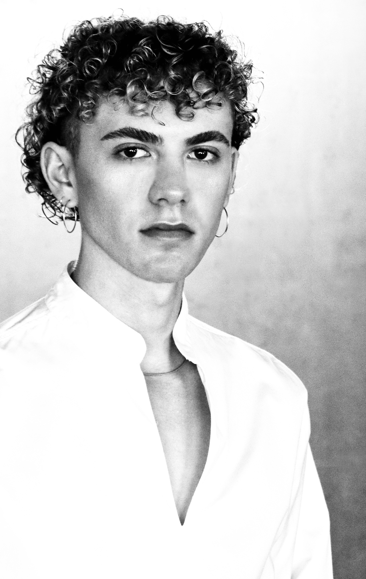 A black-and-white portrait of a person can be seen.