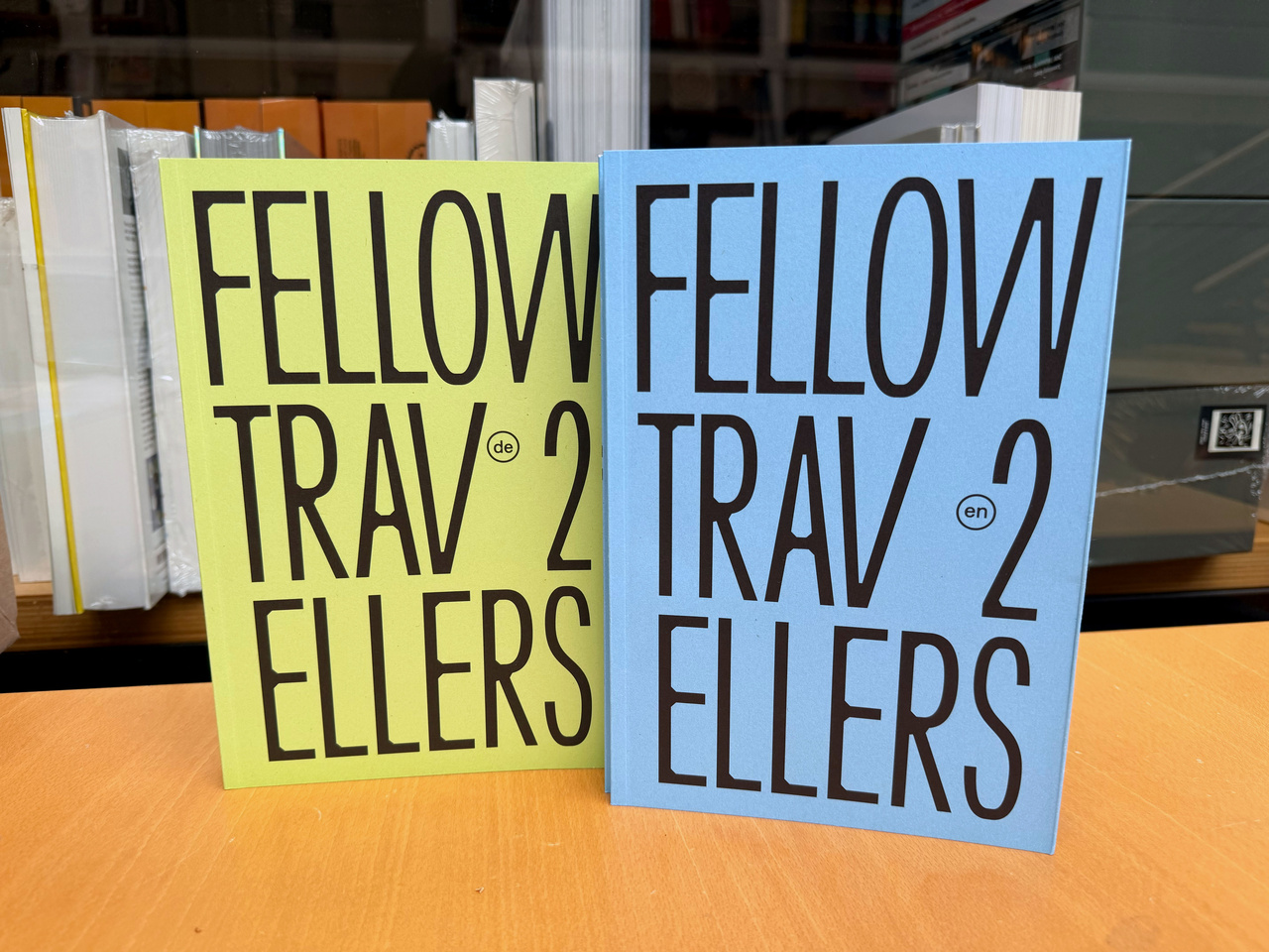 A blue and a green book with the inscription “Fellow Travellers”.