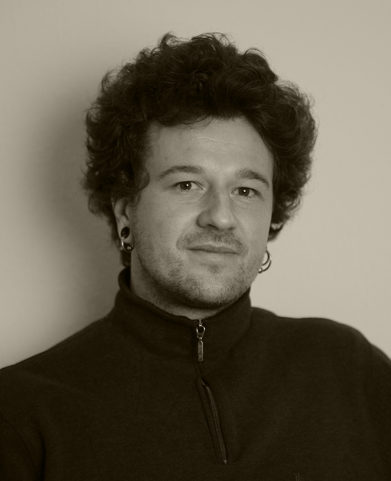 A portrait photo of Arthur Schuman is shown. 