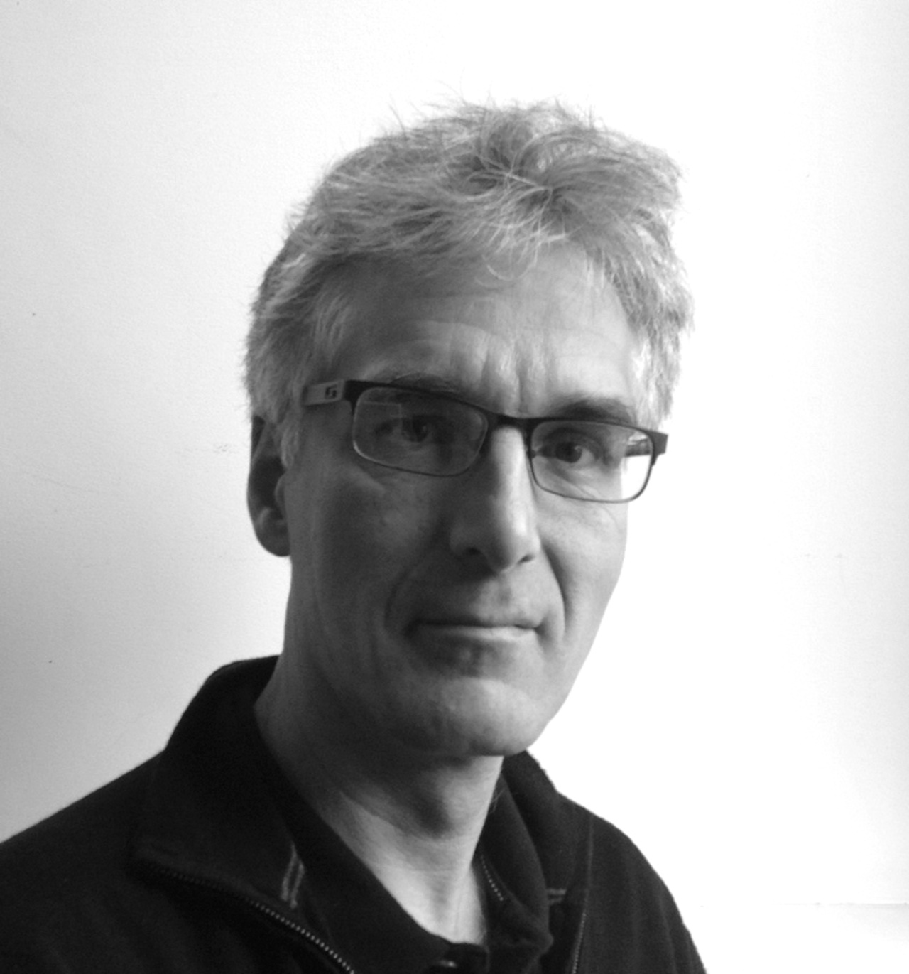 A portrait photo of Karl Sims is shown. 