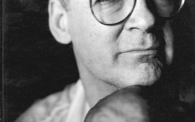 A black and white portrait of Tony Conrad